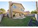 Well-maintained backyard with a cozy patio area and lush green grass, perfect for outdoor relaxation and entertaining at 7832 Desert Candle Way, Las Vegas, NV 89128