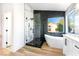 Bathroom with modern tub, a glass shower, and a sleek vanity with marble accents at 7832 Desert Candle Way, Las Vegas, NV 89128