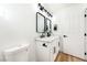 Modern bathroom featuring double sinks, sleek black fixtures, and contemporary lighting at 7832 Desert Candle Way, Las Vegas, NV 89128