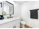 Bright bathroom with a white vanity, modern fixtures, and decorative floral accent at 7832 Desert Candle Way, Las Vegas, NV 89128