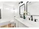 Bright bathroom with dual sinks, a tub, and modern fixtures at 7832 Desert Candle Way, Las Vegas, NV 89128