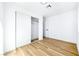 Clean bedroom with an open closet, features light-colored wood-look flooring and crisp white walls at 7832 Desert Candle Way, Las Vegas, NV 89128