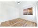 Cozy bedroom with new floors, white walls, and natural light from the window at 7832 Desert Candle Way, Las Vegas, NV 89128