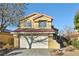 Inviting two-story home with a well-manicured lawn, mature trees, and a spacious two car garage at 7832 Desert Candle Way, Las Vegas, NV 89128