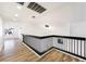 Bright upstairs hallway with modern railing and hardwood floors at 7832 Desert Candle Way, Las Vegas, NV 89128
