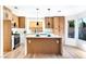 Updated kitchen with stainless steel appliances, a waterfall island, and lots of natural light at 7832 Desert Candle Way, Las Vegas, NV 89128