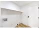 Clean laundry room featuring a storage shelf and hookups for washer and dryer at 7832 Desert Candle Way, Las Vegas, NV 89128