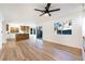 Open concept living room flowing into the kitchen with wood floors and natural light at 7832 Desert Candle Way, Las Vegas, NV 89128