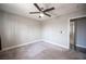 Bedroom featuring gray walls, plush carpet, ceiling fan, white trim, and a doorway at 815 Center St, Henderson, NV 89015