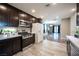 Modern kitchen featuring stainless steel appliances, dark wood cabinets, and a view into the spacious living area at 815 Center St, Henderson, NV 89015