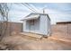 Backyard view of storage shed with double door and wood steps at 815 Center St, Henderson, NV 89015