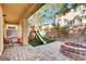Inviting backyard with a patio, a brick fire pit, green turf, and a wooden playset for  at 8456 Blackstone Ridge Ct, Las Vegas, NV 89139