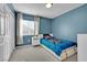 Comfortable bedroom featuring light-blue walls, plush carpeting, and a window for plenty of light at 8456 Blackstone Ridge Ct, Las Vegas, NV 89139