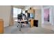 Bright bedroom featuring a functional workstation and neutral carpeting at 8456 Blackstone Ridge Ct, Las Vegas, NV 89139