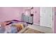 Charming bedroom with pink walls and a cozy bed, creating a warm and inviting atmosphere for children at 8456 Blackstone Ridge Ct, Las Vegas, NV 89139