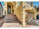 Charming yellow home with a brick staircase and an attached garage, showcasing a classic architectural design at 8456 Blackstone Ridge Ct, Las Vegas, NV 89139