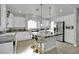 Bright kitchen featuring a center island with bar seating, stone countertops, stainless steel appliances, and wood flooring at 8456 Blackstone Ridge Ct, Las Vegas, NV 89139