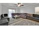 Spacious living room featuring a large sectional sofa and patterned rug at 8456 Blackstone Ridge Ct, Las Vegas, NV 89139