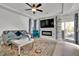 Stylish living room with a ceiling fan, fireplace, and balcony access at 8456 Blackstone Ridge Ct, Las Vegas, NV 89139