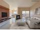 Living room featuring a fireplace, white couch and television at 9000 Las Vegas Blvd # 1097, Las Vegas, NV 89123