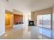 Open living room with fireplace, media center, neutral walls, and balcony access at 9000 Las Vegas Blvd # 1097, Las Vegas, NV 89123