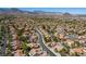 Scenic aerial view of a meticulously maintained desert community, highlighting landscaped streets and tile roofs at 9028 Firebird Dr, Las Vegas, NV 89134