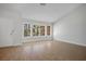 Well-lit living room with large windows and wood-look tile floors throughout at 9028 Firebird Dr, Las Vegas, NV 89134