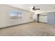 Spacious bedroom with plush carpeting, a ceiling fan, and a closet with sliding doors at 9139 Scallop Reef Ave, Las Vegas, NV 89147