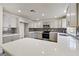Bright kitchen featuring gray cabinets, stainless steel appliances, a long countertop and mosaic backsplash at 9139 Scallop Reef Ave, Las Vegas, NV 89147