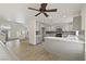 Open-concept kitchen featuring gray cabinets, stainless steel appliances, mosaic backsplash, and a center island at 9139 Scallop Reef Ave, Las Vegas, NV 89147