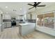Bright kitchen featuring gray cabinets, stainless steel appliances, mosaic backsplash, and a breakfast bar at 9139 Scallop Reef Ave, Las Vegas, NV 89147