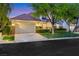 Charming single-story home boasts lush front lawn, mature landscaping, and a two-car garage at 9524 Chalgrove Village Ave, Las Vegas, NV 89145