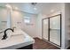 Modern bathroom featuring a double vanity with quartz countertops and a glass-enclosed shower with a tiled surround at 9825 Lost Horse Ave, Las Vegas, NV 89178