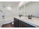 Well-lit bathroom featuring dual sinks, quartz countertops, and a shower-tub combo, combining style and functionality at 9825 Lost Horse Ave, Las Vegas, NV 89178