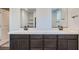 Contemporary bathroom with double vanity, quartz countertops, and dark wood cabinets offering ample storage space at 9825 Lost Horse Ave, Las Vegas, NV 89178