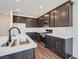 Modern kitchen with stainless steel appliances, a peninsula island, and white backsplash tiling at 9825 Lost Horse Ave, Las Vegas, NV 89178