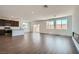 Bright, open-concept living space features hardwood floors, a fireplace, and access to a kitchen and backyard at 9825 Lost Horse Ave, Las Vegas, NV 89178