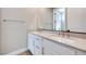 Bathroom featuring double sink vanity, chrome fixtures, large mirror, and white cabinetry at 990 Golden Summit Dr, Las Vegas, NV 89138