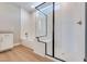 Modern bath with a sleek shower, a tub, white textured walls, and stylish fixtures at 990 Golden Summit Dr, Las Vegas, NV 89138