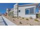 A modern home with desert landscaping, and sidewalk at 990 Golden Summit Dr, Las Vegas, NV 89138