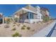 A modern home showcasing a stylish exterior with patterned accents and low-maintenance landscaping at 990 Golden Summit Dr, Las Vegas, NV 89138