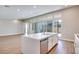 Open concept kitchen island with seating, stainless steel appliances, and sliding doors to the backyard at 990 Golden Summit Dr, Las Vegas, NV 89138