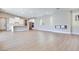 Open-concept living area with a fireplace, modern lighting, hard surface flooring, and a spacious kitchen at 990 Golden Summit Dr, Las Vegas, NV 89138