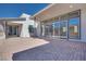 Paver patio with sliding glass doors and neutral colored exterior at 990 Golden Summit Dr, Las Vegas, NV 89138