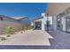 Backyard patio featuring stylish pavers, desert landscaping, and a modern home design at 990 Golden Summit Dr, Las Vegas, NV 89138