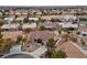 Aerial view of a single-story house in a residential community with desert landscaping and nearby golf course at 9917 Arbuckle Dr, Las Vegas, NV 89134