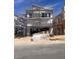 Two-story home under construction with modern design, scaffolding, and a two car garage at 10004 River Corral St, Las Vegas, NV 89166