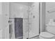 Clean white bathroom featuring a glass shower with a convenient grab bar and shower caddy at 10035 Oak Creek Canyon Ave, Las Vegas, NV 89147