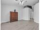 Bedroom featuring wood-style floors, neutral walls, ceiling fan and dark-stained dresser at 10035 Oak Creek Canyon Ave, Las Vegas, NV 89147