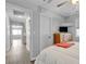 Bright bedroom featuring a ceiling fan, gray walls, wood floors and a TV at 10035 Oak Creek Canyon Ave, Las Vegas, NV 89147